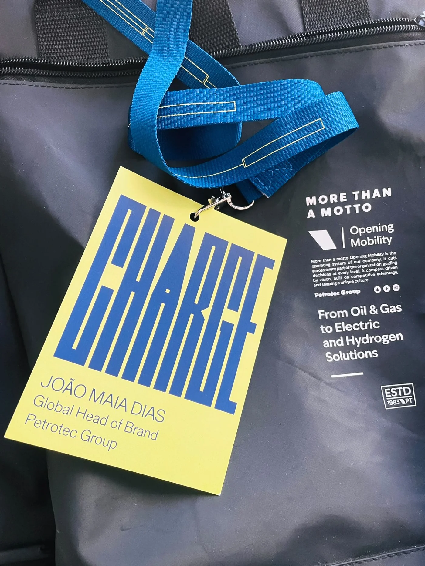 CHARGE 2026 conference badge and Opening Mobility bag