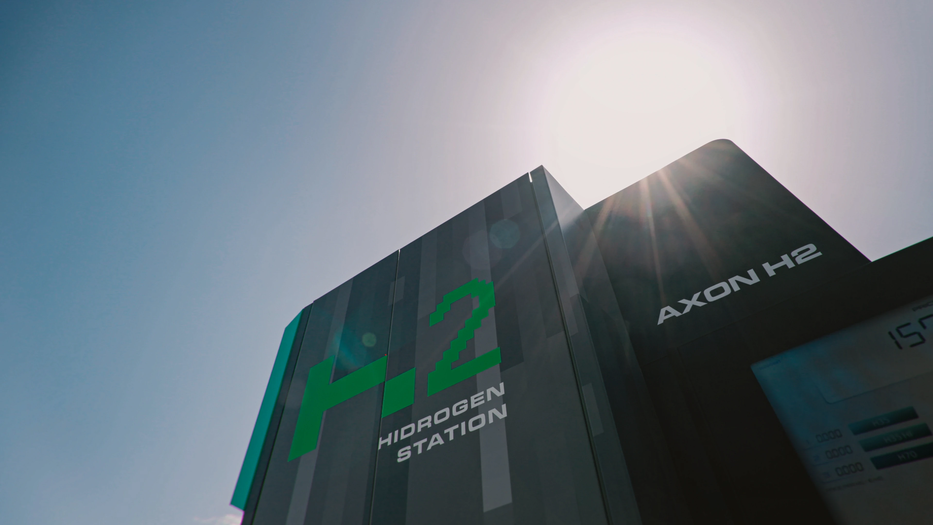 H2 Hydrogen Station and AXON H2 dispenser, low-angle with sun flare