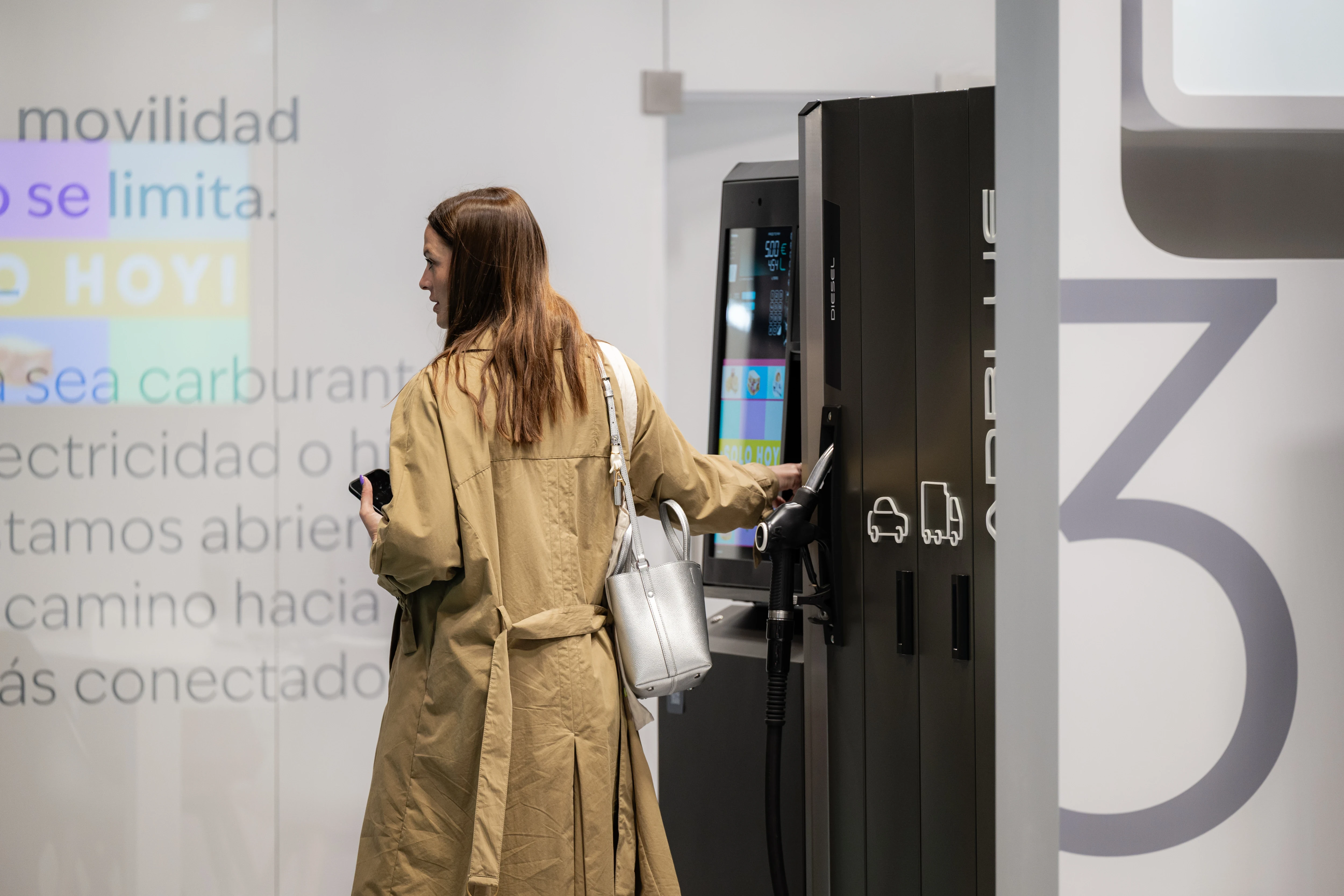 Visitor interacting with Petrotec fuel dispenser at Motortec trade show
