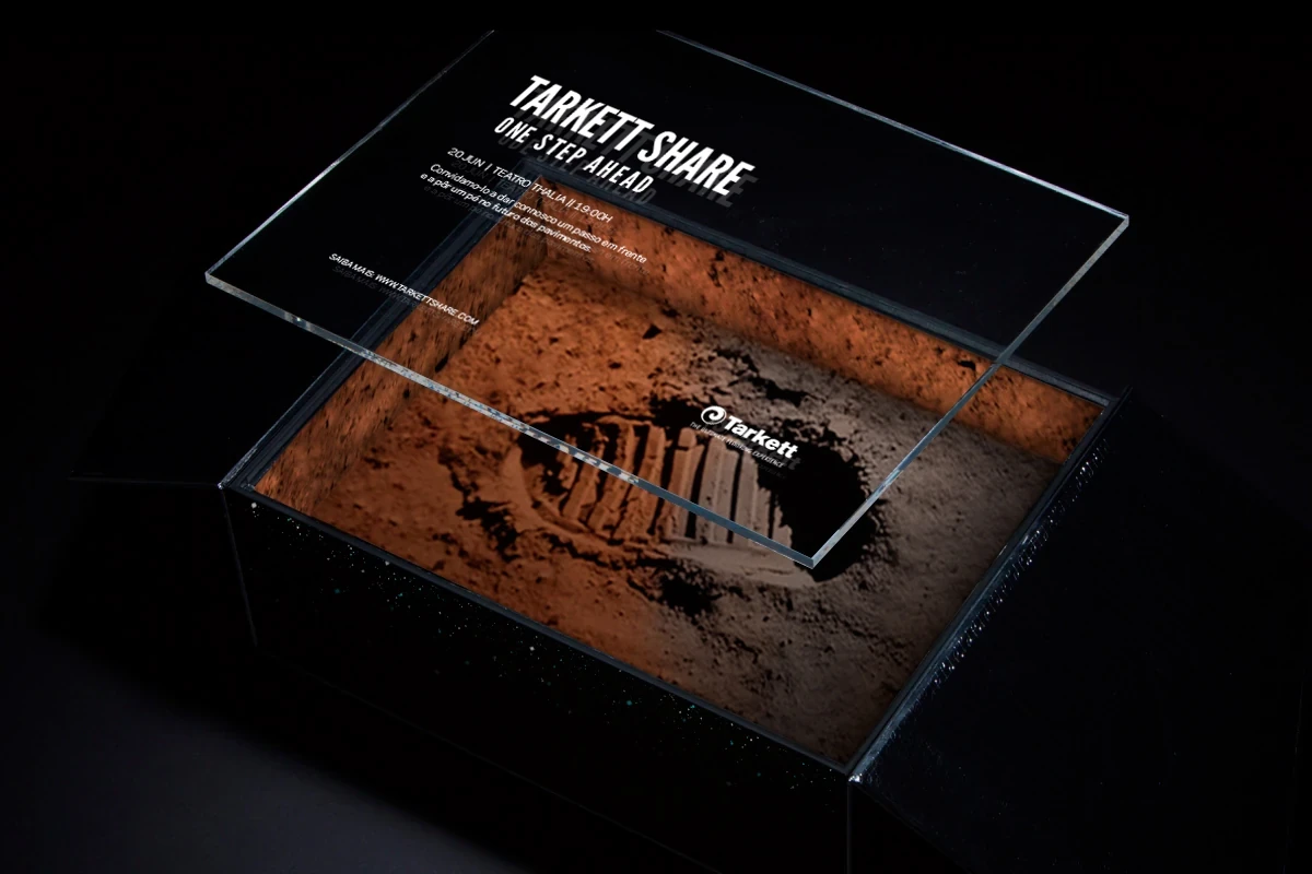 Tarkett Share invitation: glass lid revealing moon footprint and event details